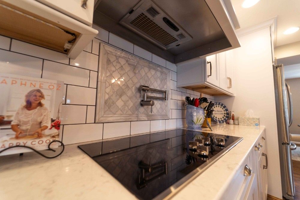 A kitchen with a stove top oven and a book on the counter.