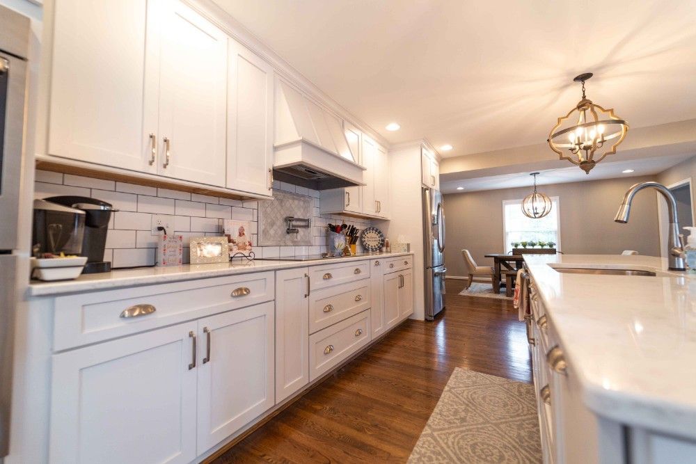 A kitchen with white cabinets and stainless steel appliances.