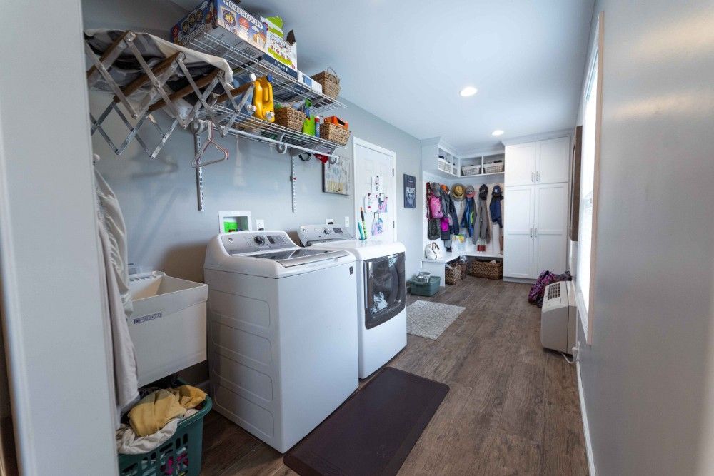 A laundry room with a washer and dryer and a sink.