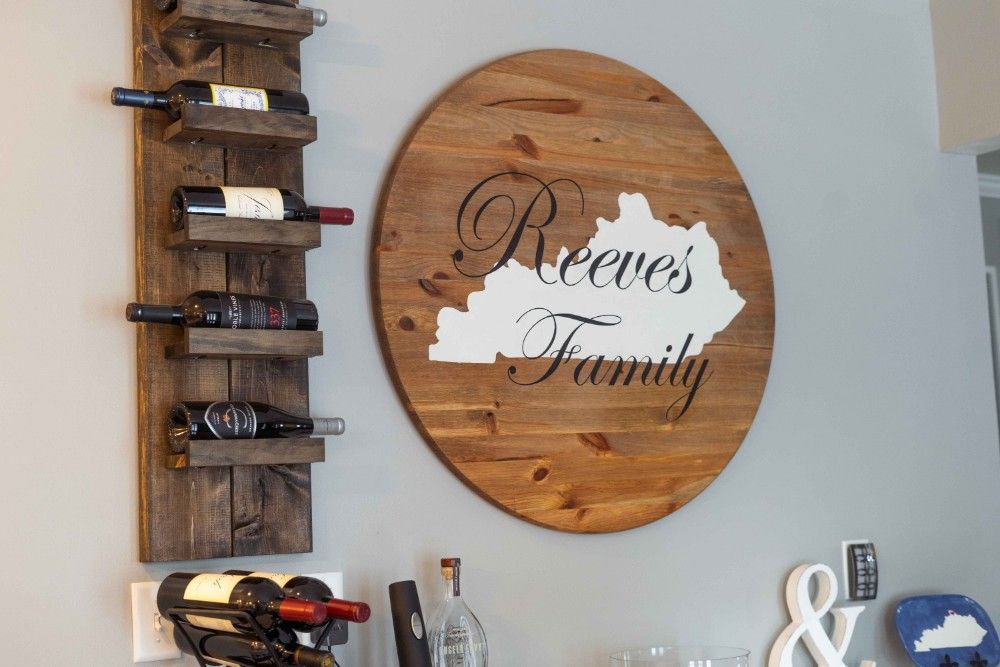 A wooden sign on a wall that says reeves family