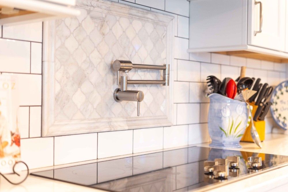 A kitchen with a stove top oven and a sink.