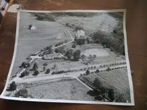 A black and white photo of an aerial view of a farm.