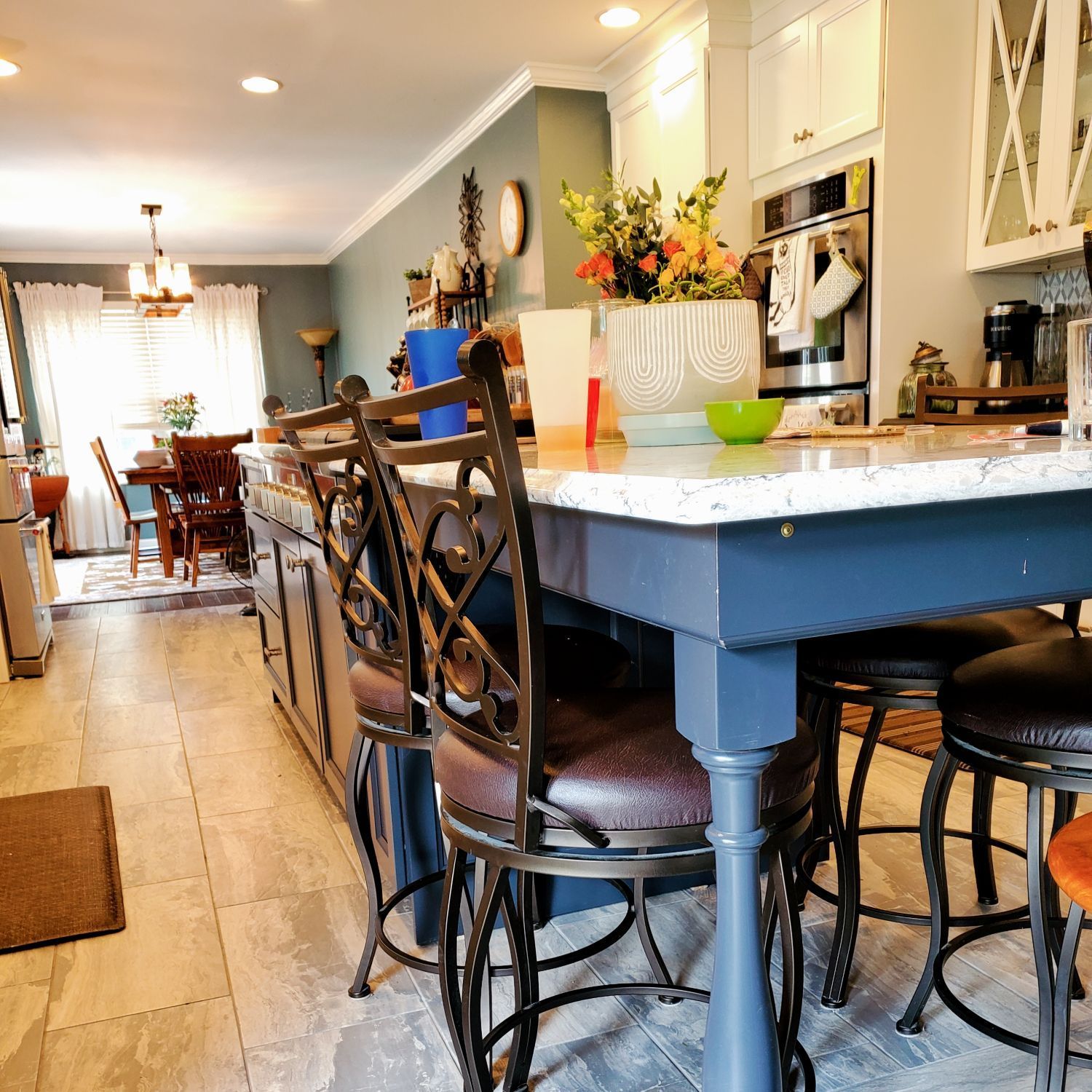 A kitchen with a table and chairs in it