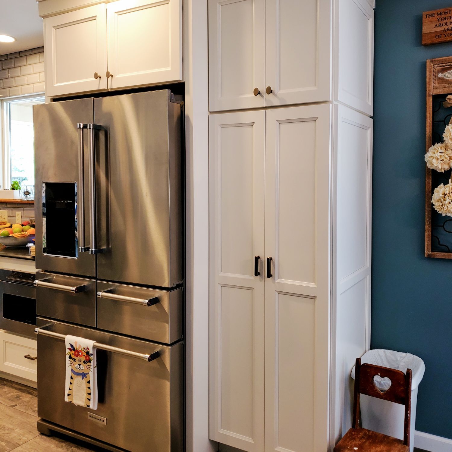 A kitchen with stainless steel appliances and white cabinets