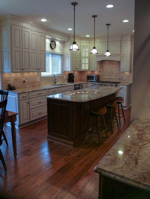 A kitchen with white cabinets and granite counter tops