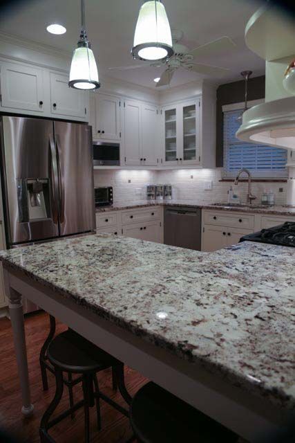 A kitchen with granite counter tops and stainless steel appliances