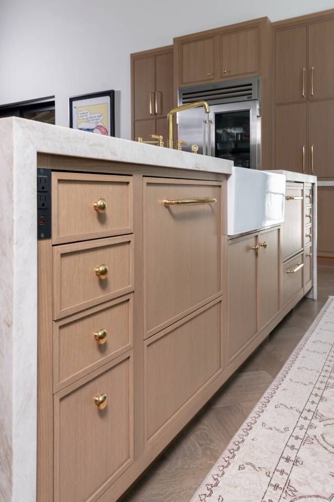 A kitchen with wooden cabinets and a white sink