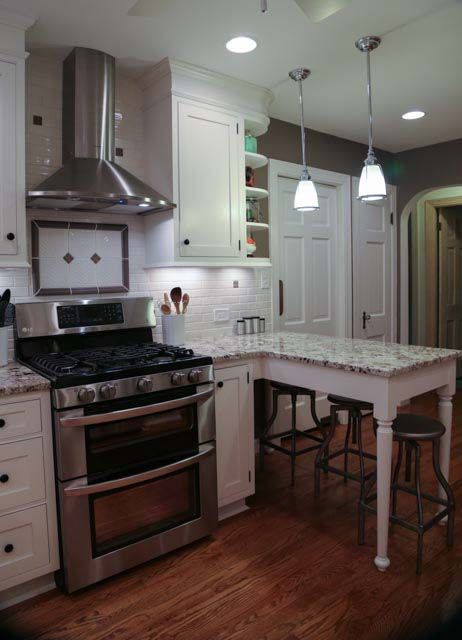A kitchen with stainless steel appliances and white cabinets