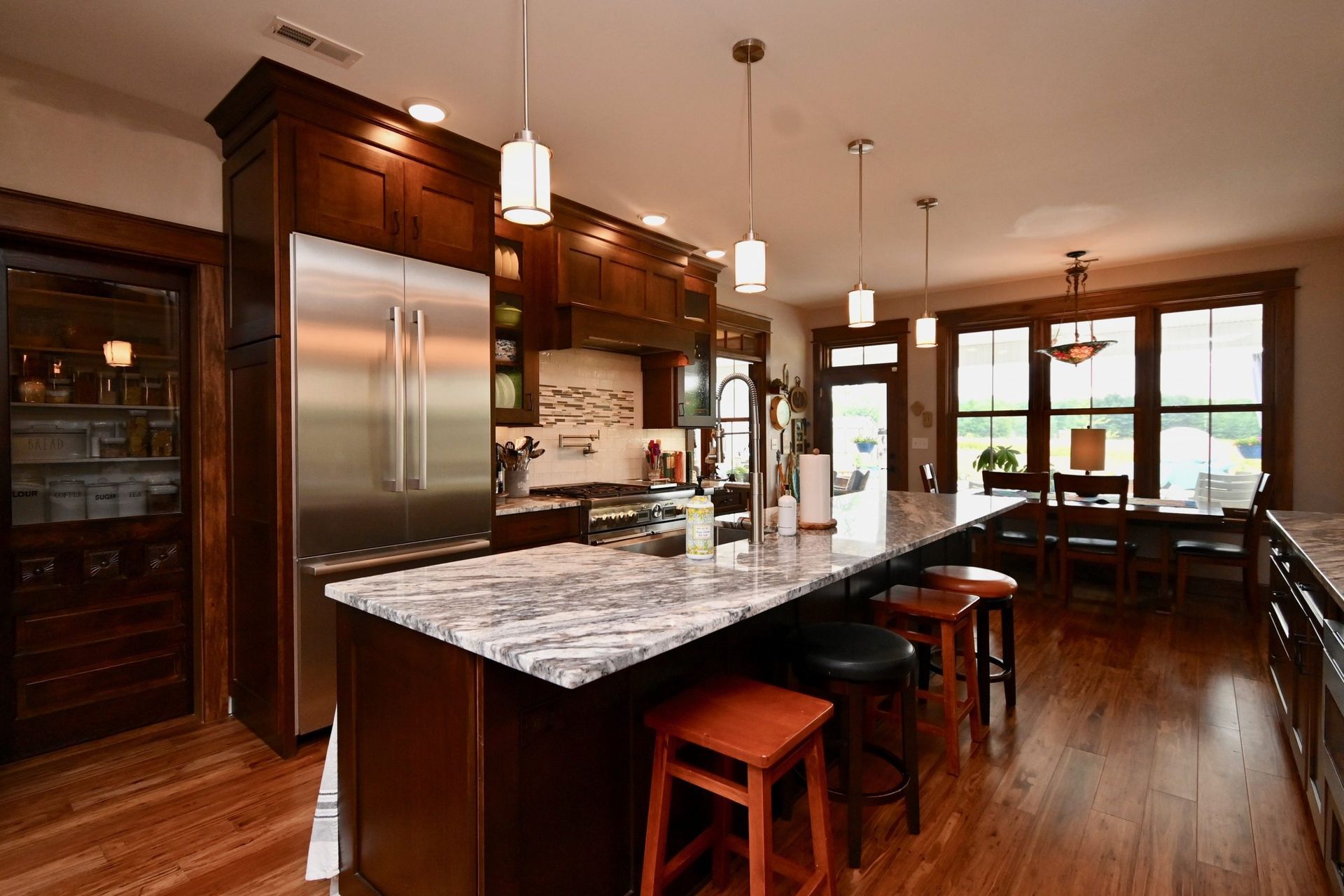 A kitchen with a large island and stools