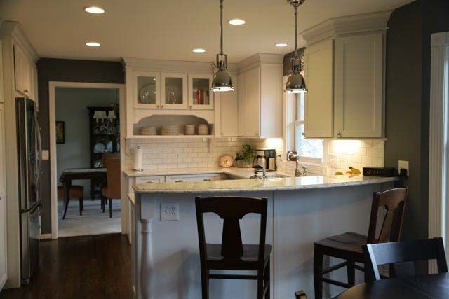 A kitchen with white cabinets and a large island