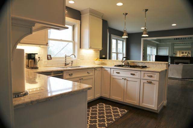 A kitchen with white cabinets and granite counter tops