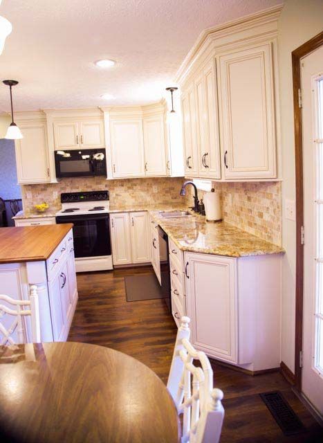 A kitchen with white cabinets and granite counter tops