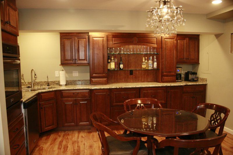 A kitchen with a table and chairs and a chandelier