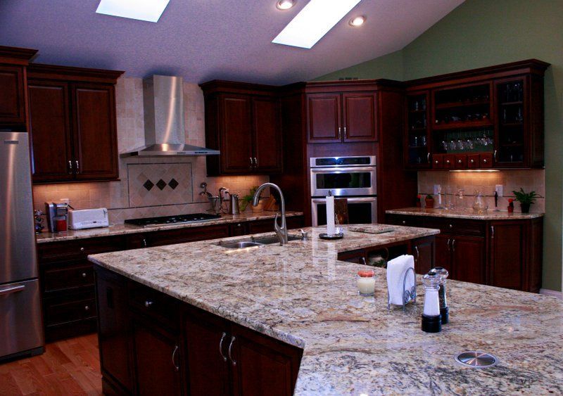 A kitchen with granite counter tops and stainless steel appliances