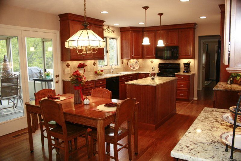 A kitchen with a table and chairs in it