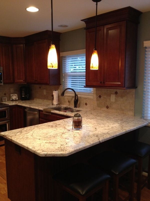 A kitchen with granite counter tops and wooden cabinets