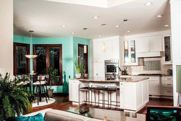 A living room and kitchen in a house with blue walls.