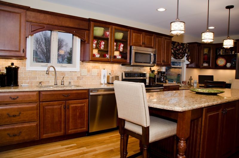 A kitchen with stainless steel appliances and wooden cabinets