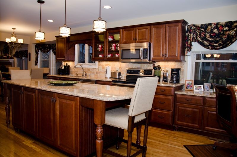A kitchen with stainless steel appliances and wooden cabinets
