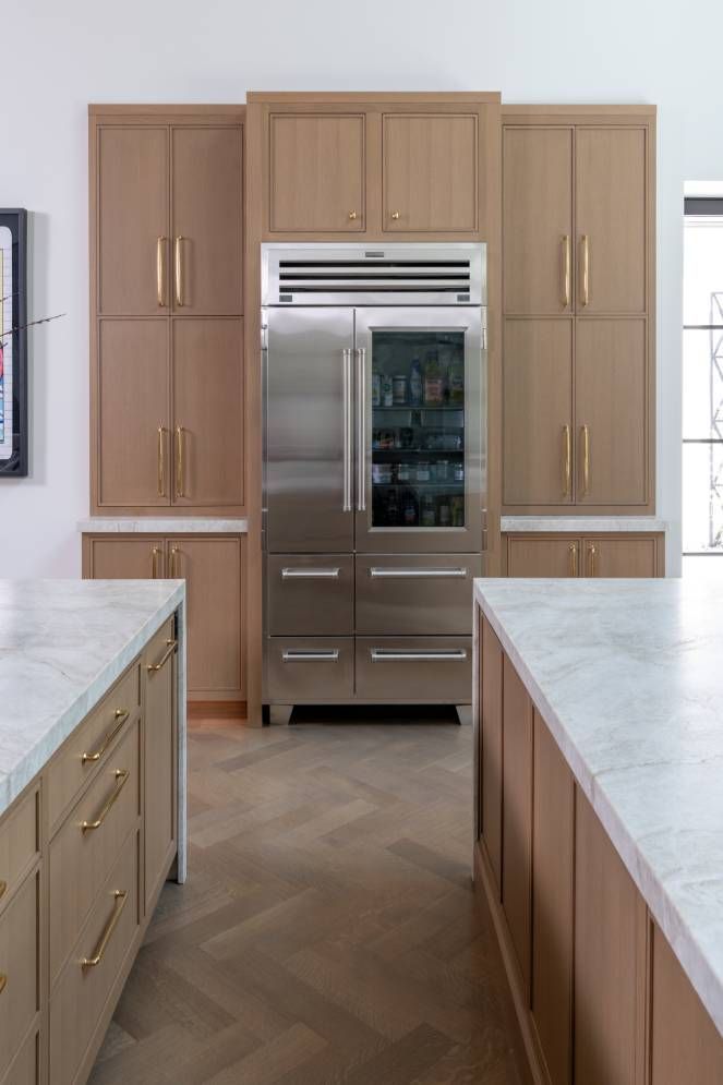 A kitchen with stainless steel appliances and wooden cabinets.