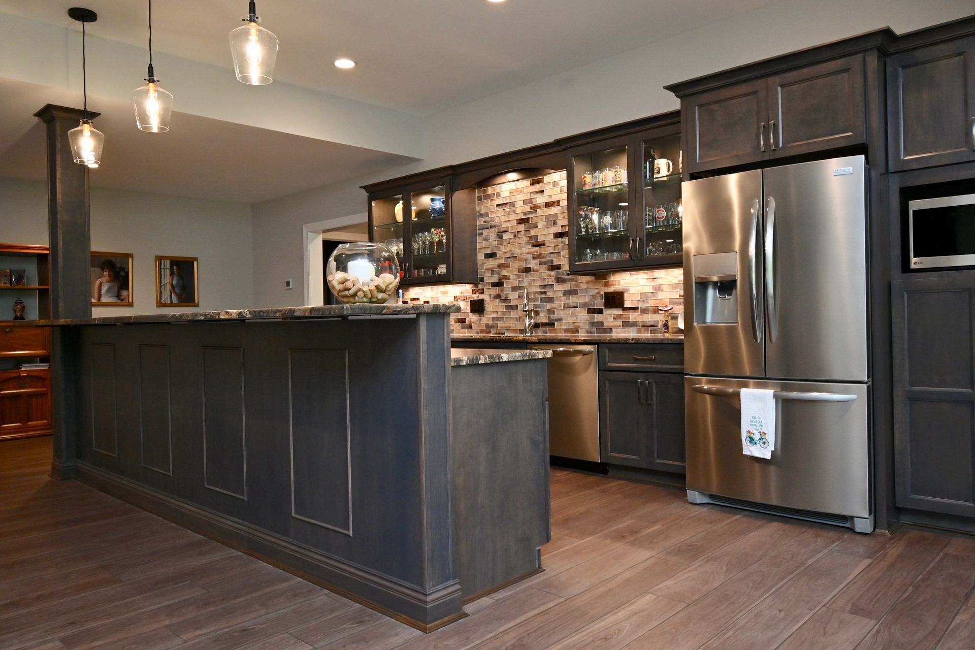 A kitchen with stainless steel appliances and a large island.