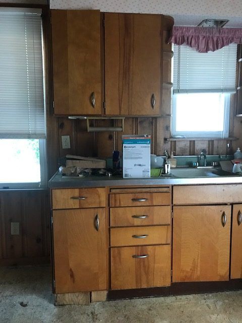 A kitchen with wooden cabinets and a sink