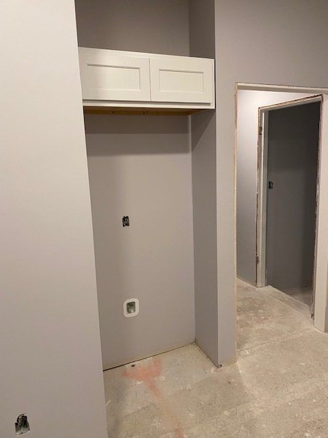 A room with a closet and a door in it.