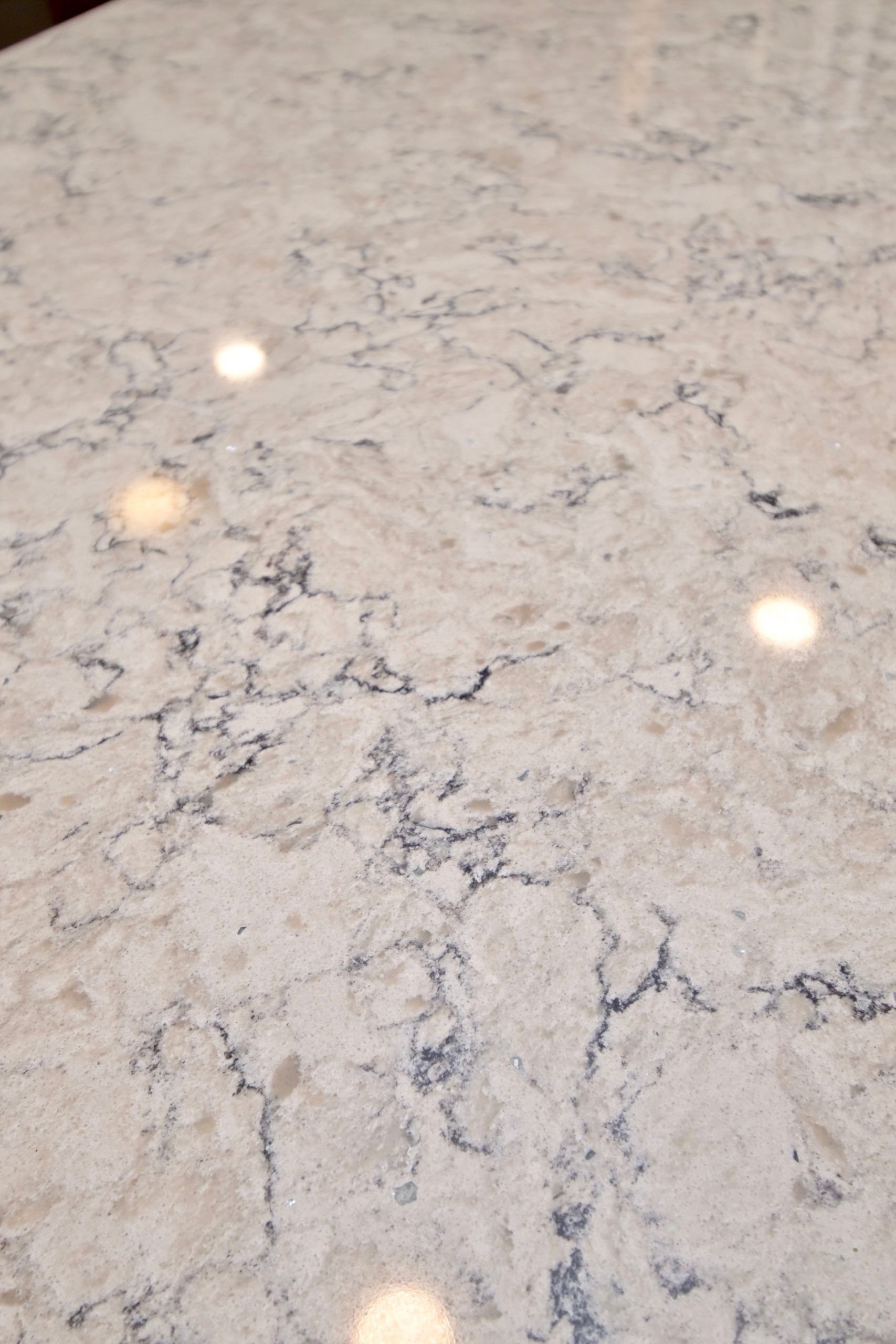 A close up of a white marble counter top in a kitchen.