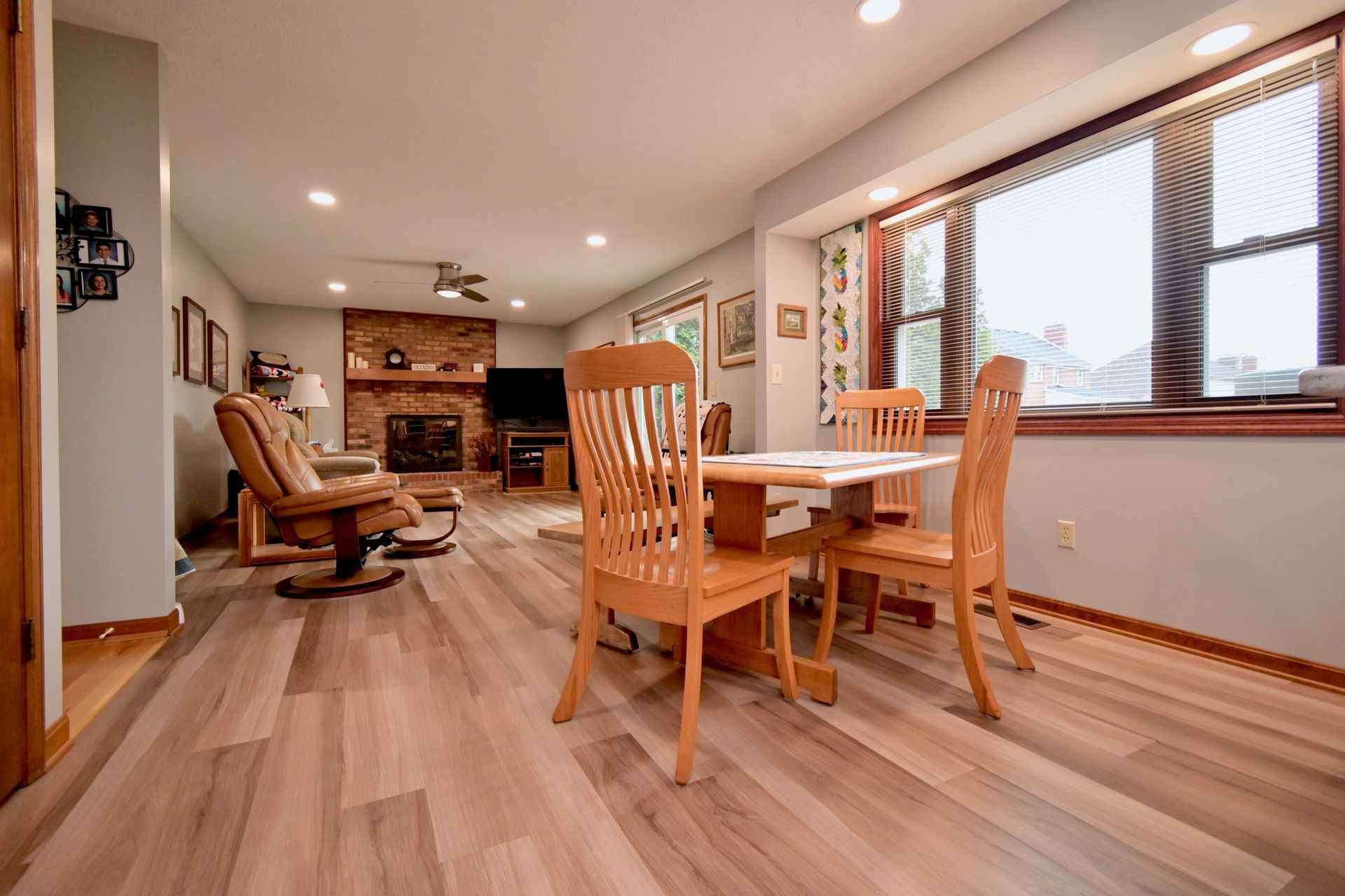 A living room with a table and chairs and a fireplace.