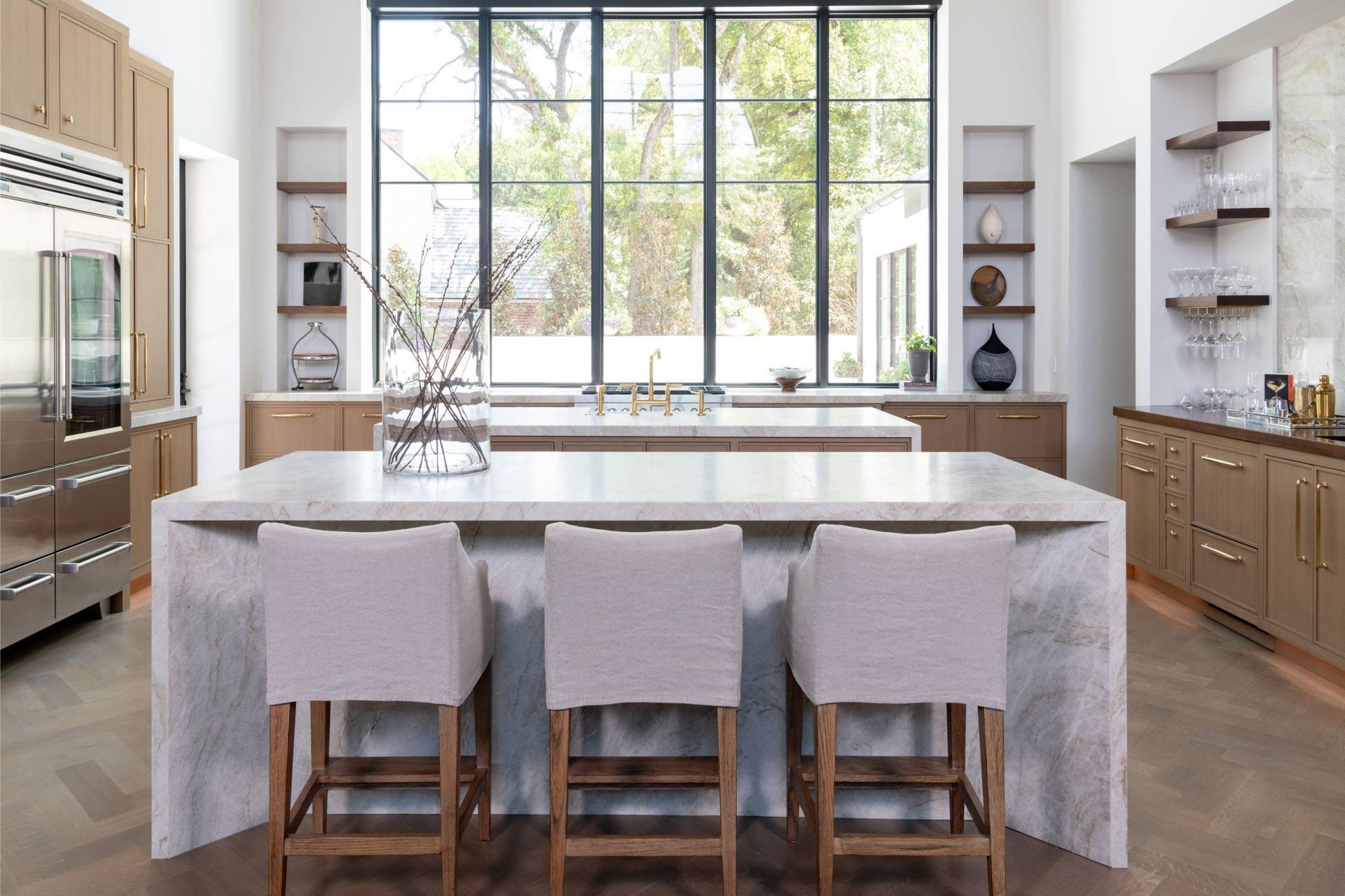 A kitchen with a large island and stools