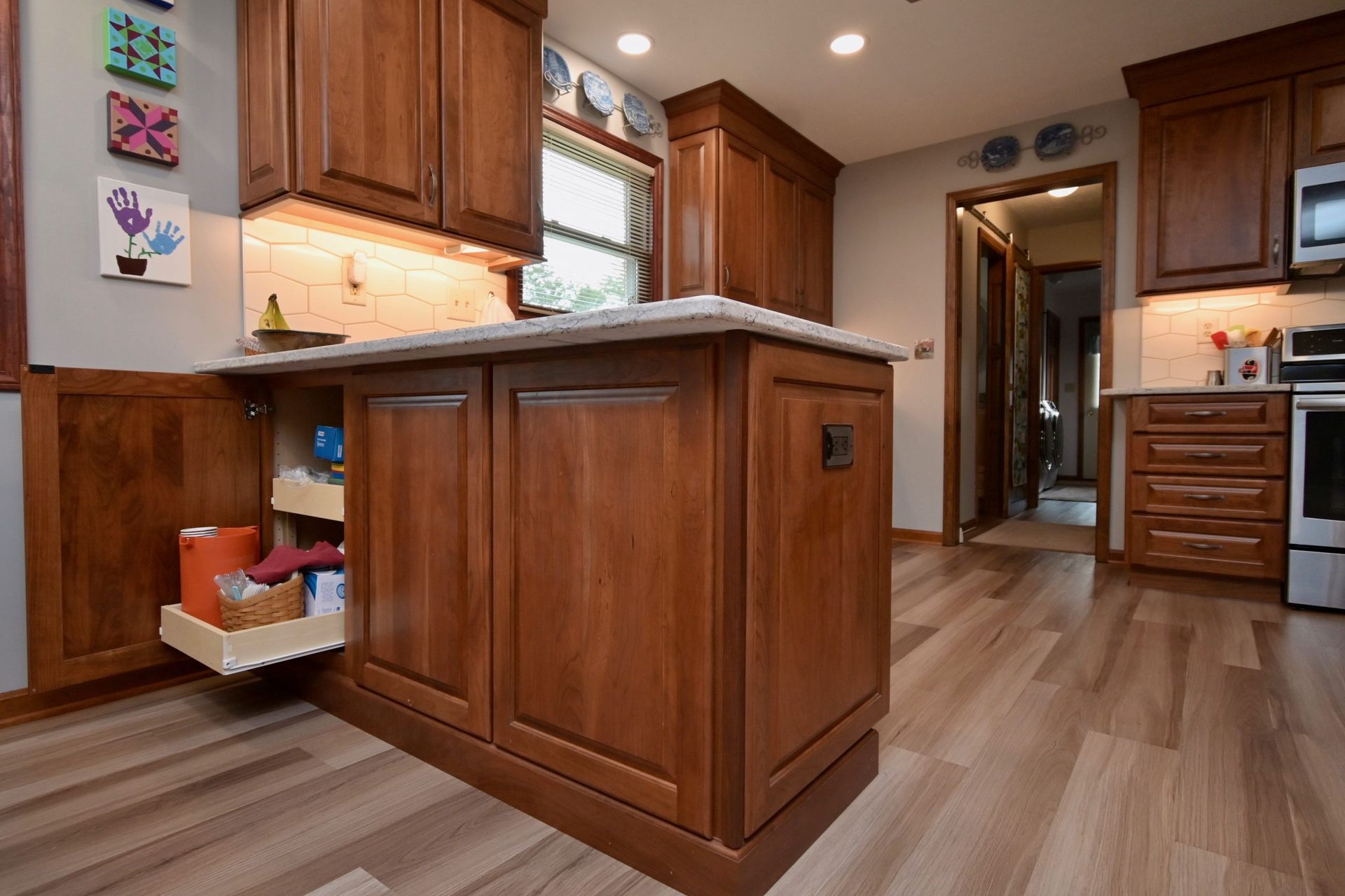 A kitchen with wooden cabinets and a large island.