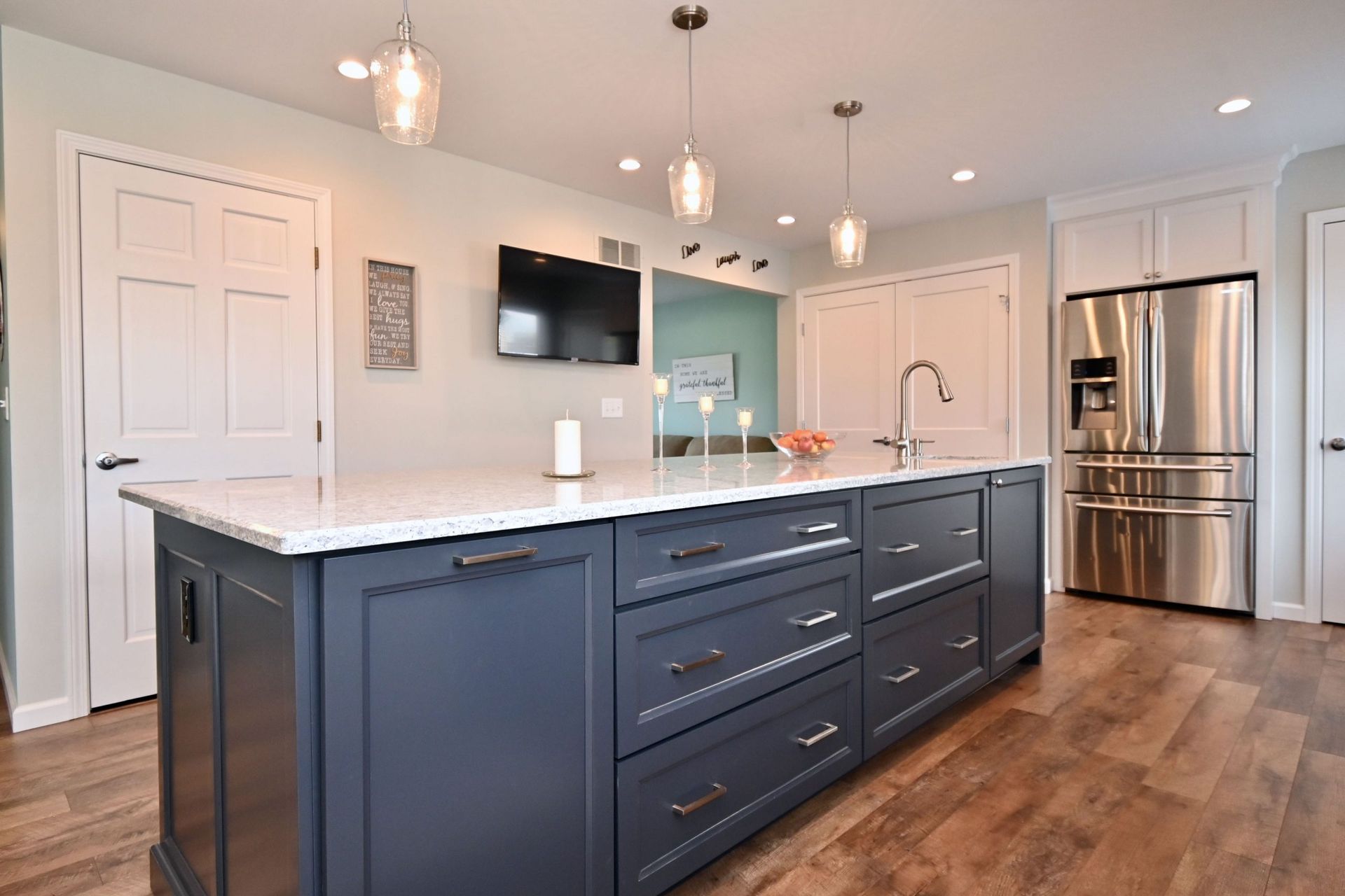 A kitchen with a large island and stainless steel appliances.