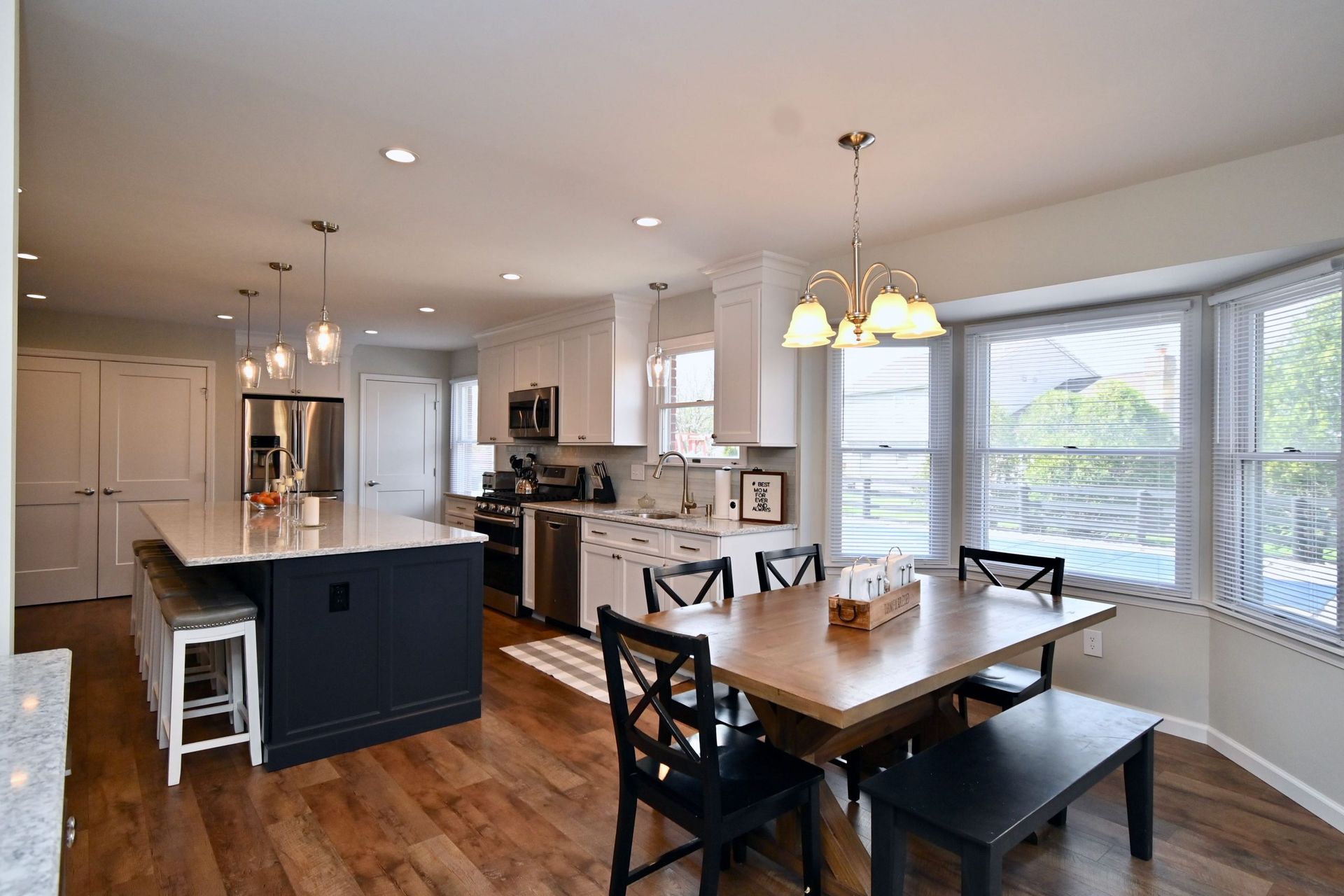 A kitchen and dining room in a house with a table and chairs.