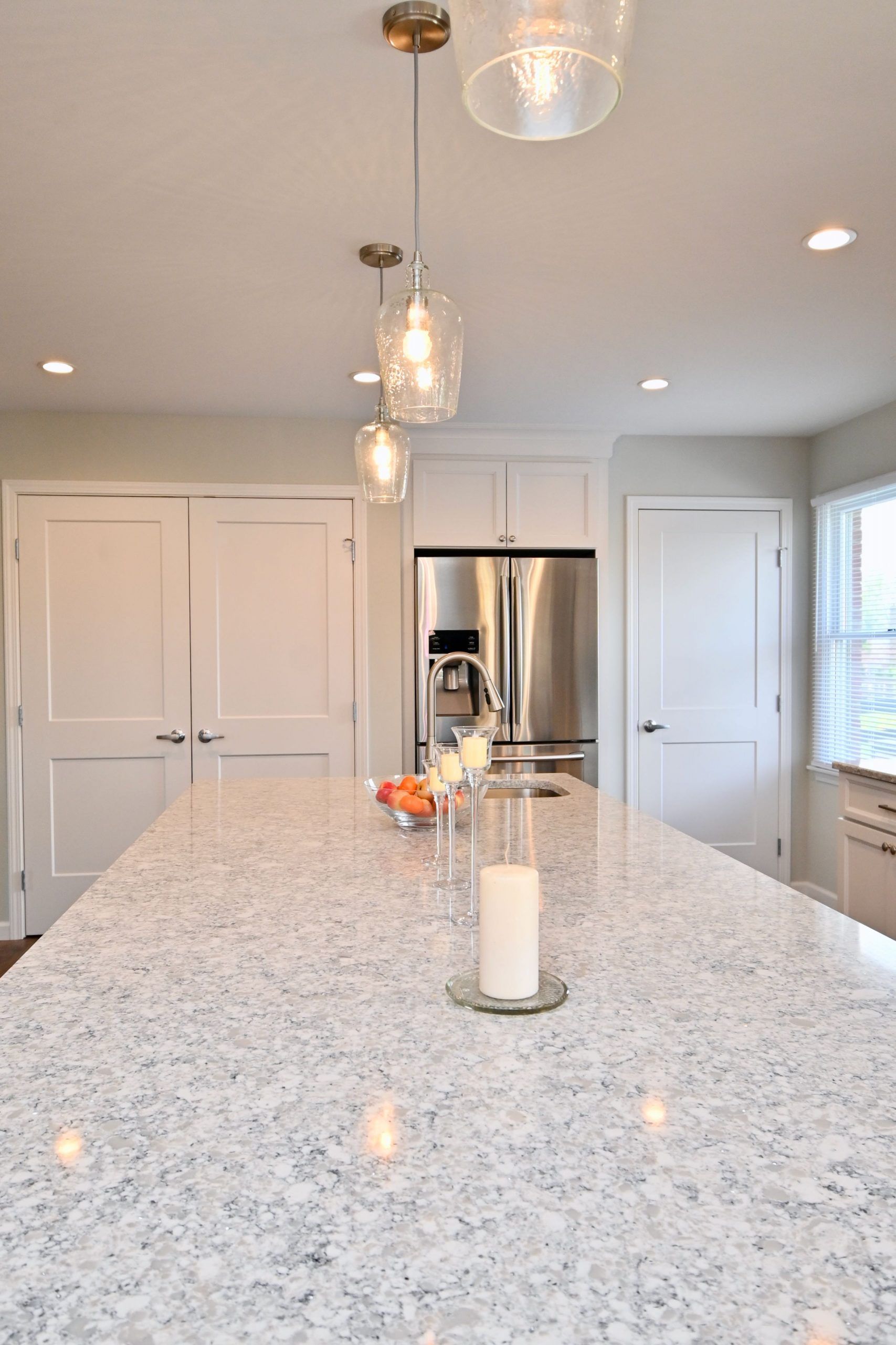 There is a candle on the counter in the kitchen.