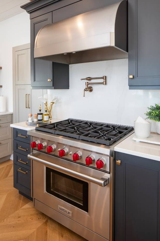 A kitchen with a stove top oven and a sink.