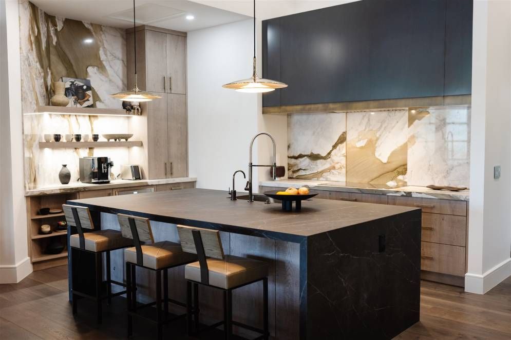A kitchen with a large island and stools.