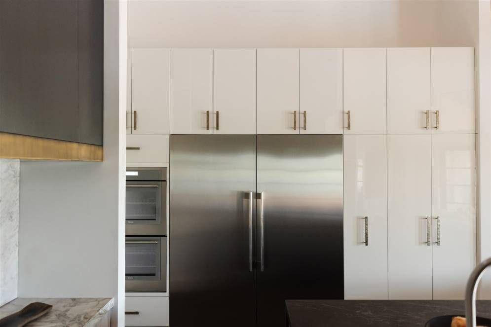 A kitchen with stainless steel appliances and white cabinets
