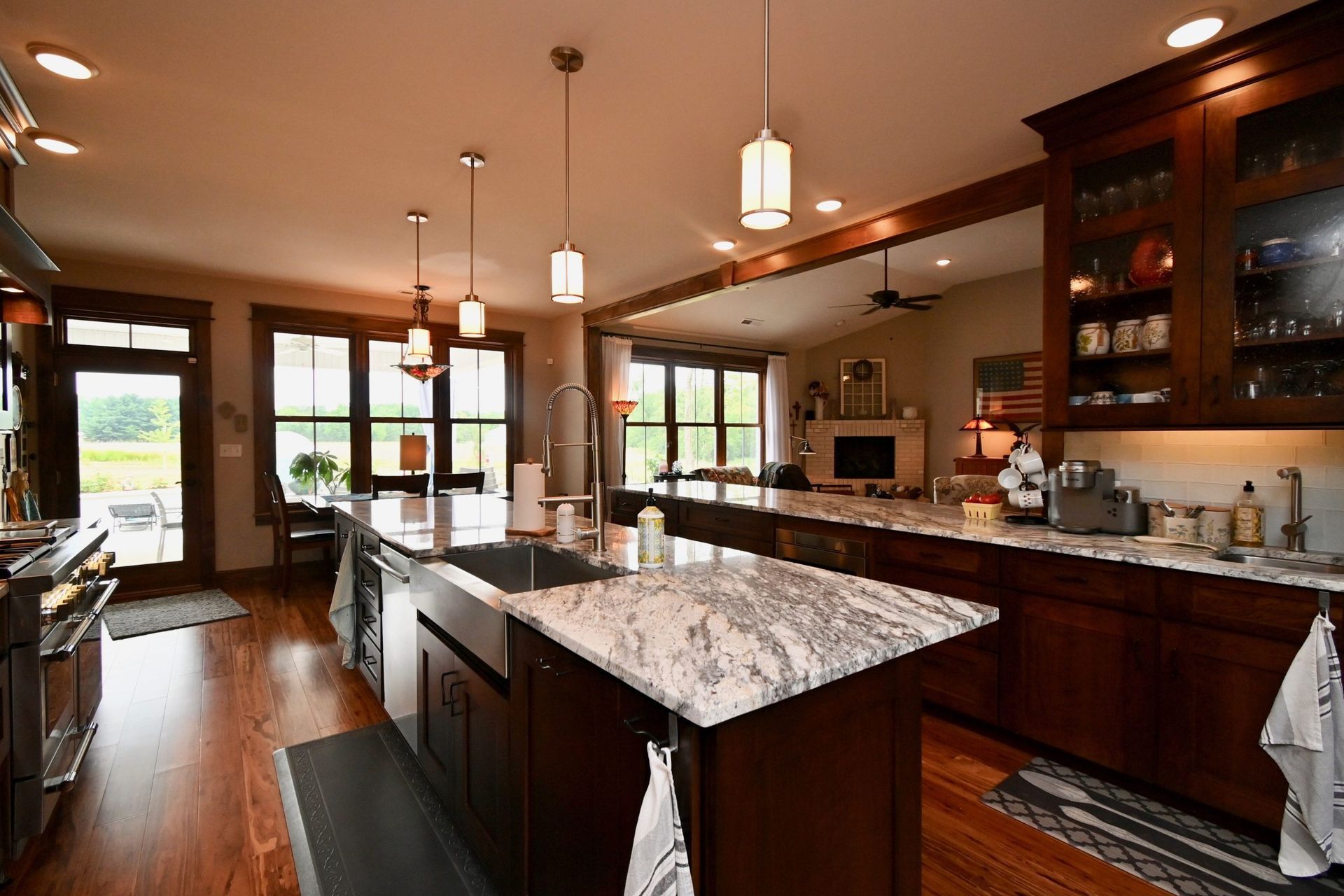 A kitchen with a large island in the middle and a sink.