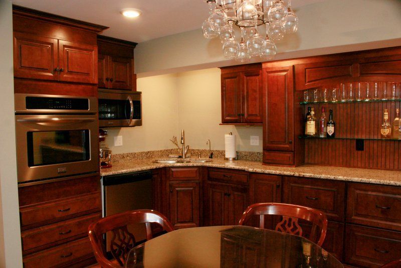 A kitchen with a table and chairs and a chandelier