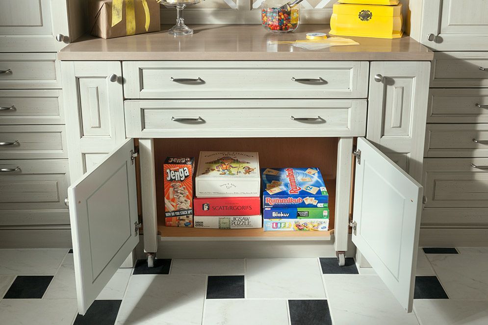 A cabinet with the doors open and boxes of cereal in it