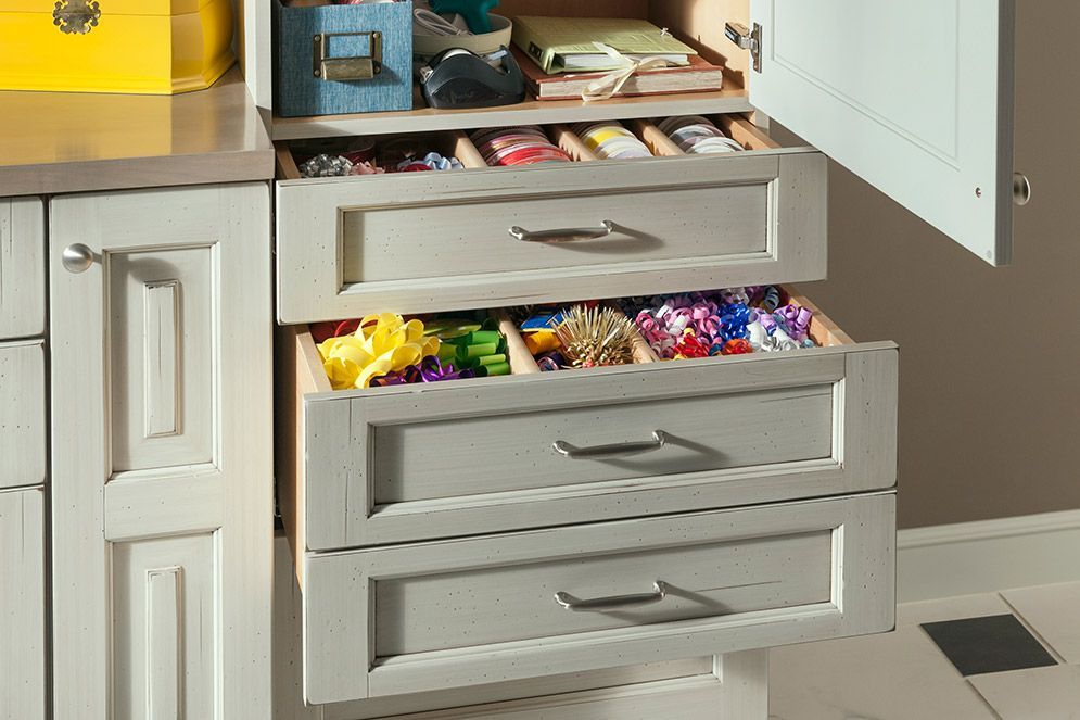 A drawer in a cabinet is open and filled with candy.