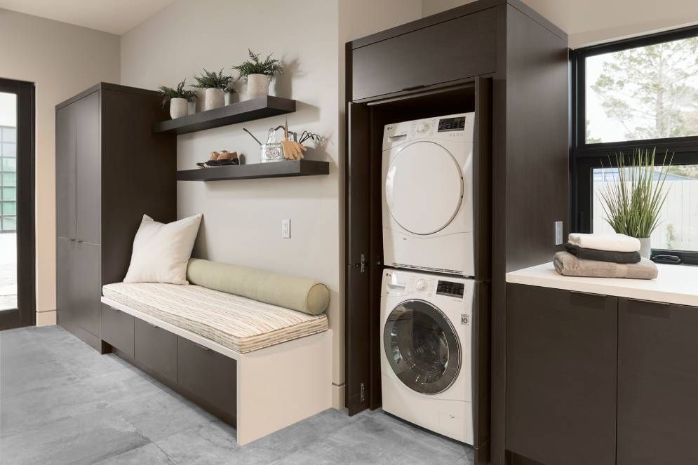 A laundry room with a washer and dryer stacked on top of each other.
