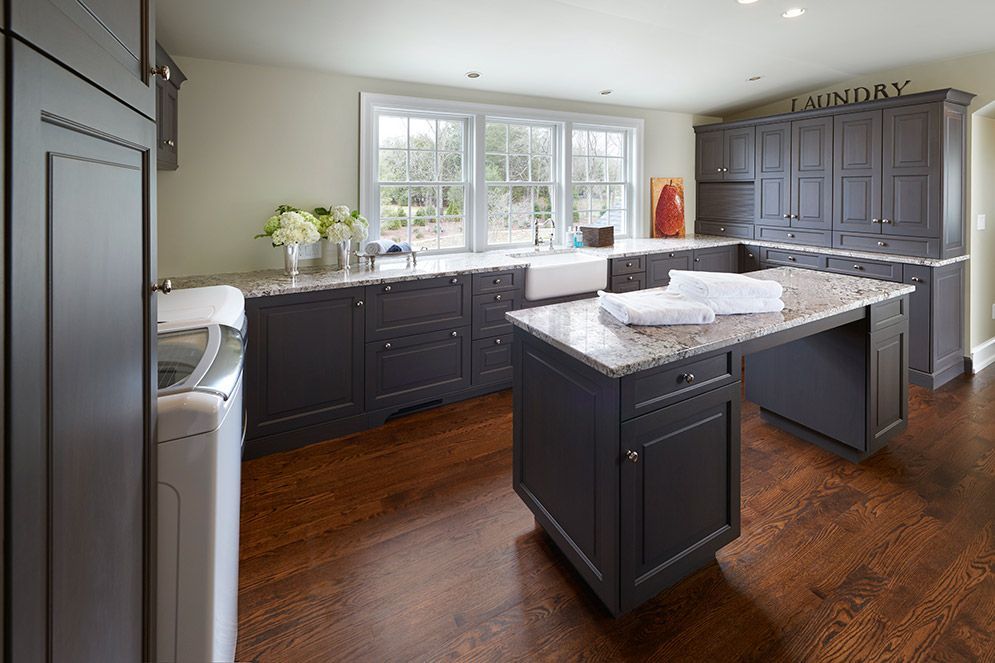 A laundry room with a large island and a washer and dryer