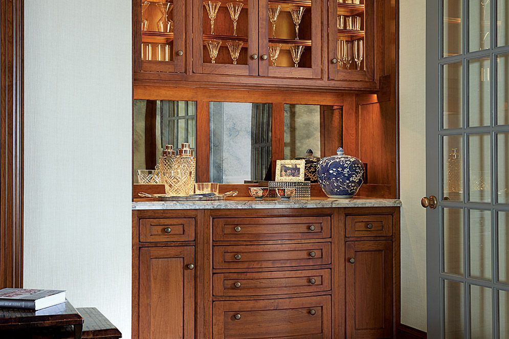 A wooden cabinet with drawers and a mirror