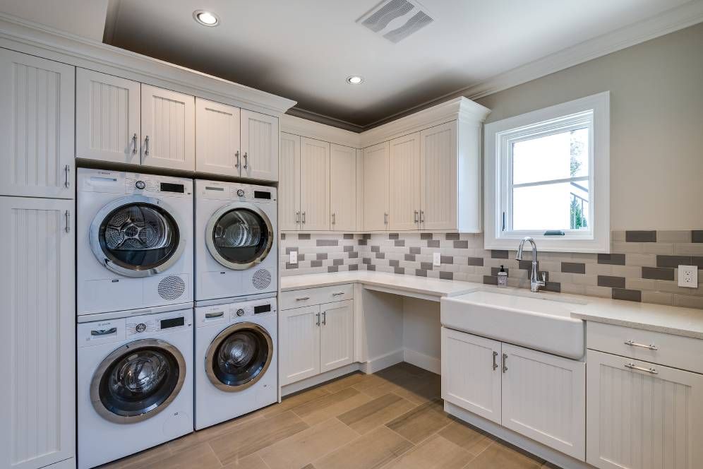 A laundry room with a washer and dryer stacked on top of each other.