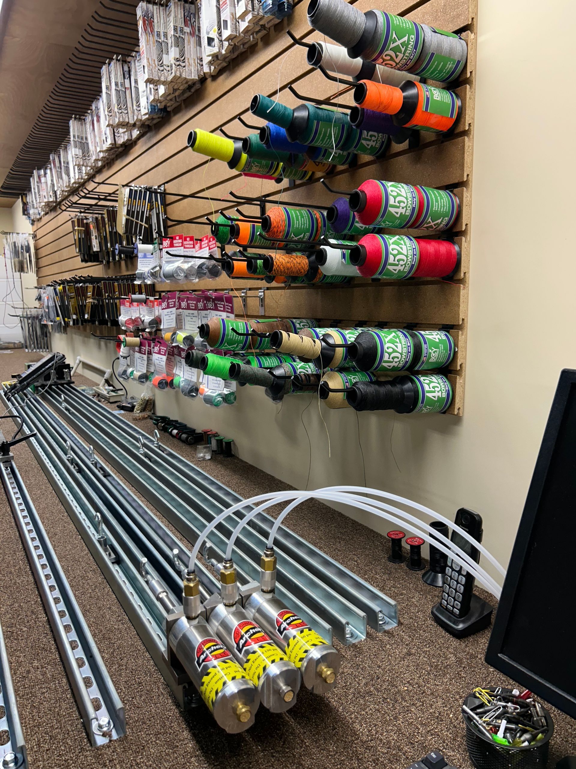 A bunch of bottles are hanging on a wall in a store.