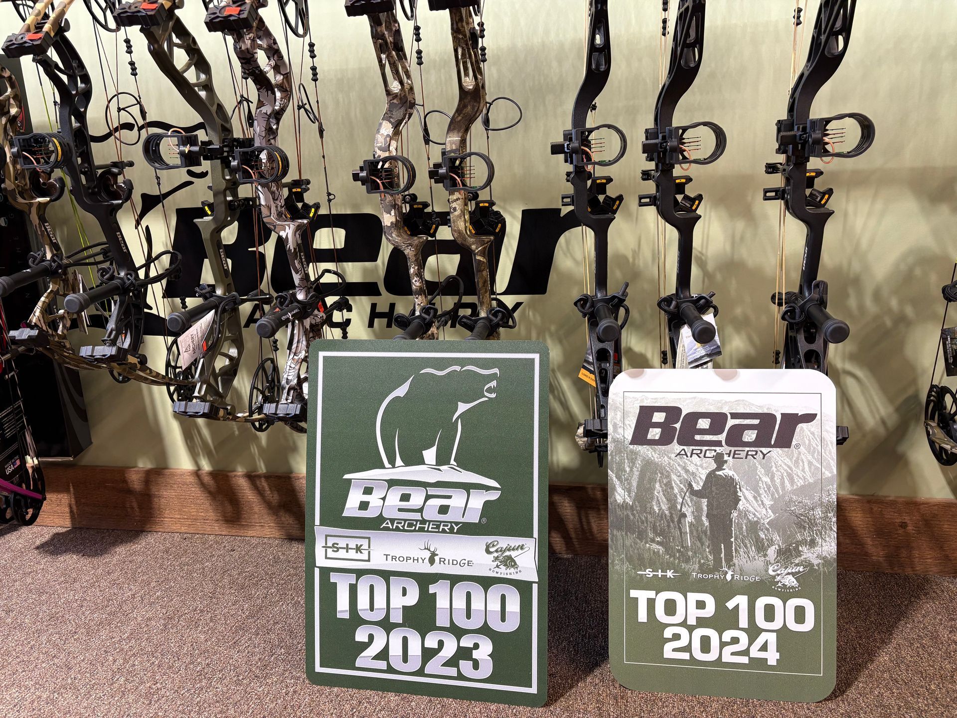 A sign that says top 100 2023 next to a sign that says top 100 2024