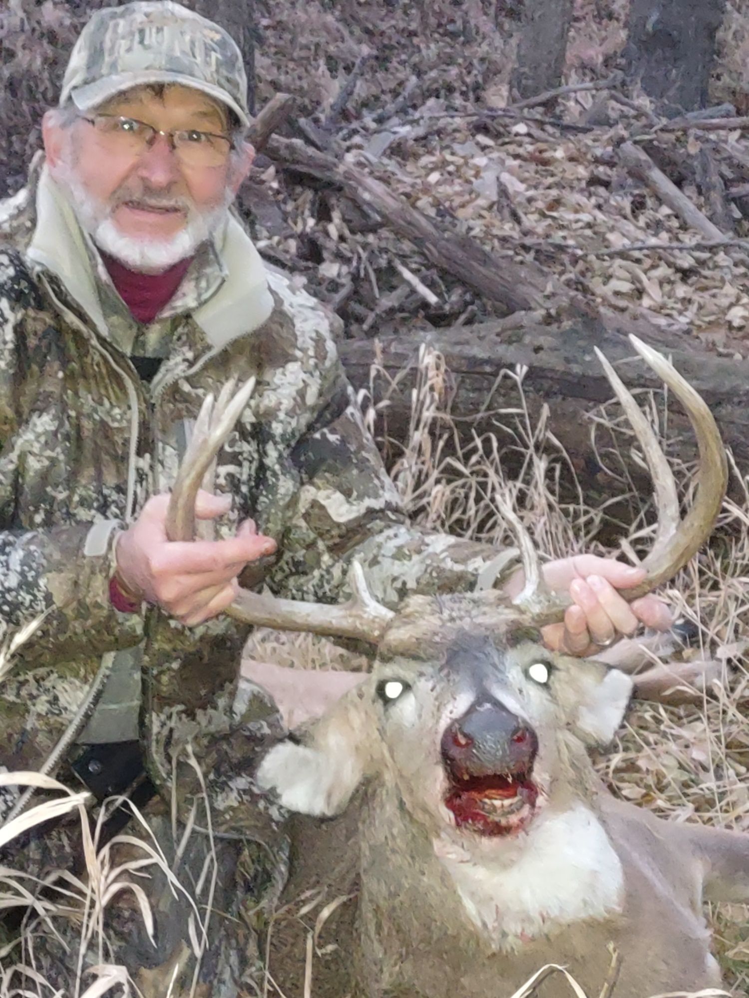 man holding a dead deer
