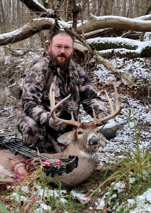 man with a dead deer catch