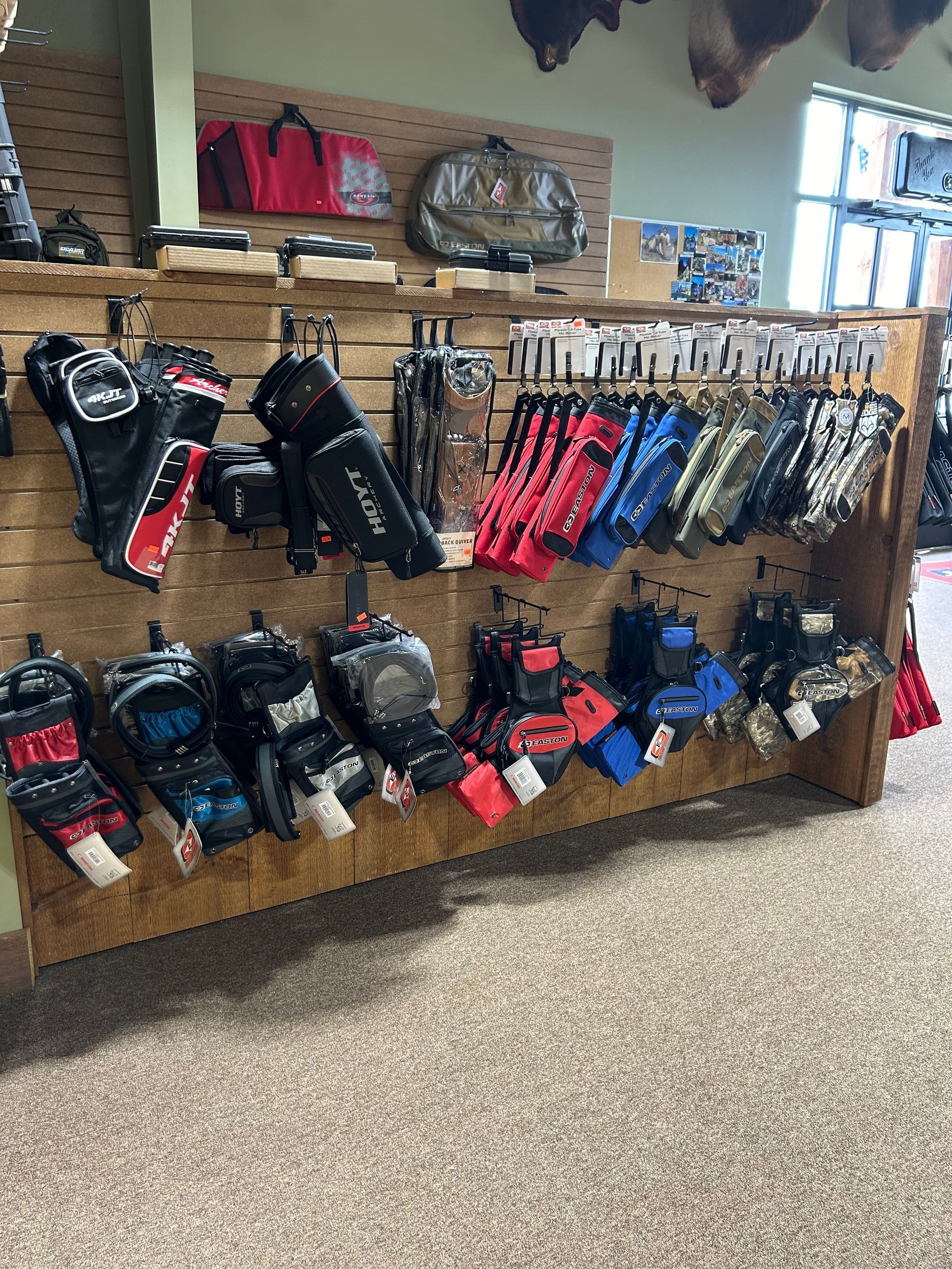 many different types of gloves hanging on a wall in a store